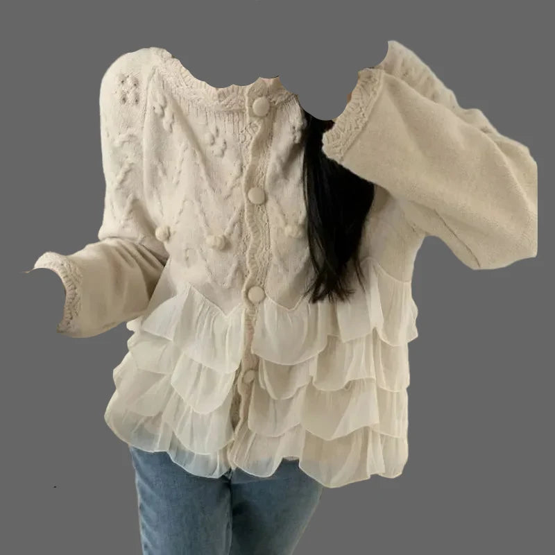 Beige loose-fit knit sweater with frill trim, worn as cozy autumn/winter outerwear